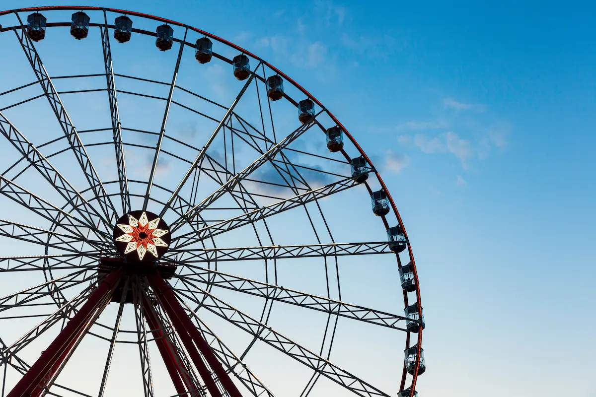Ferris wheel against a clear blue evening sky symbolizing perspective emotional cycles and personal growth in trauma therapy annapolis