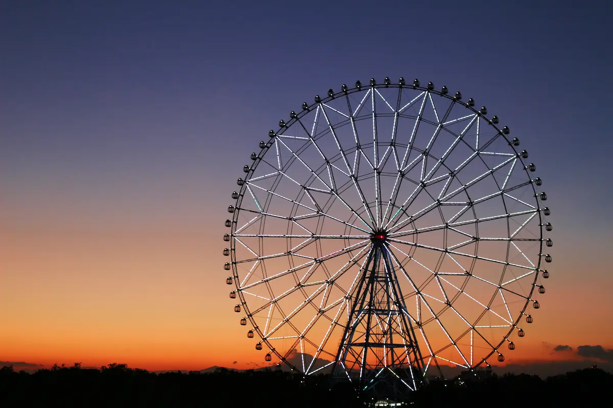 Ferris wheel glowing at sunset symbolizing perspective lifes cycles reflection and finding joy during change and growth