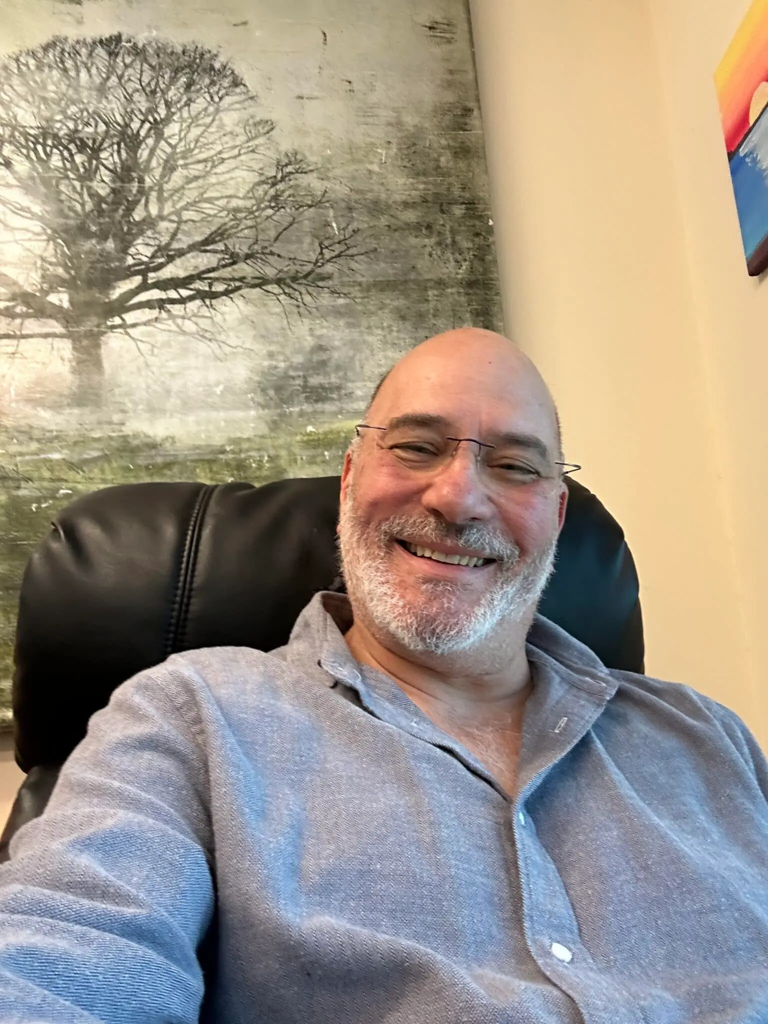 Dr adam klein seated in an office chair