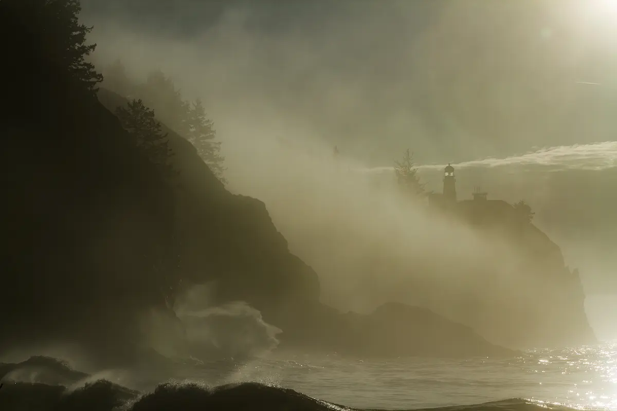 Misty coastal cliffs with a distant lighthouse shining through ocean fog symbolizing hope guidance and resilience during uncertainty and healing