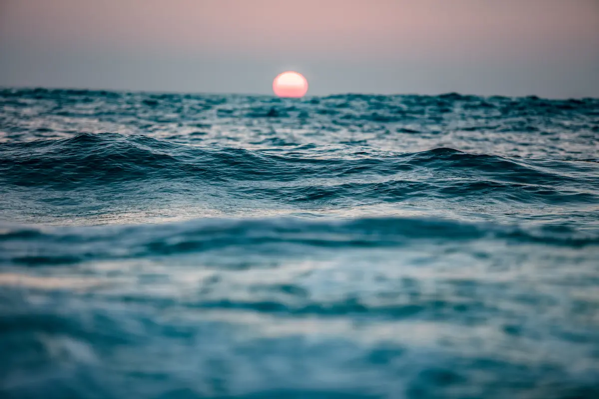Ocean waves at sunset beneath a soft sky conveying calm reflection in depth oriented therapy annapolis