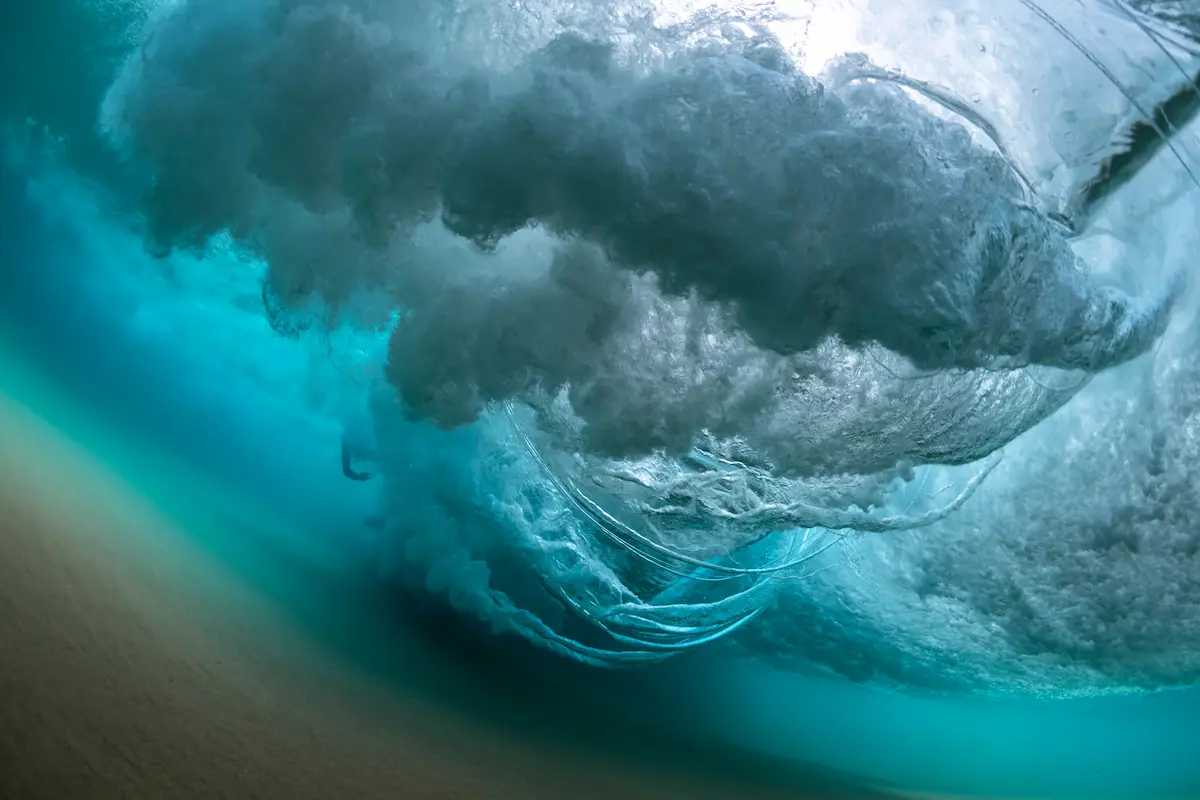 Powerful underwater wave curling with swirling currents and turbulence symbolizing overwhelming emotions inner struggle resilience and navigating the depths of trauma healing and emotional recovery