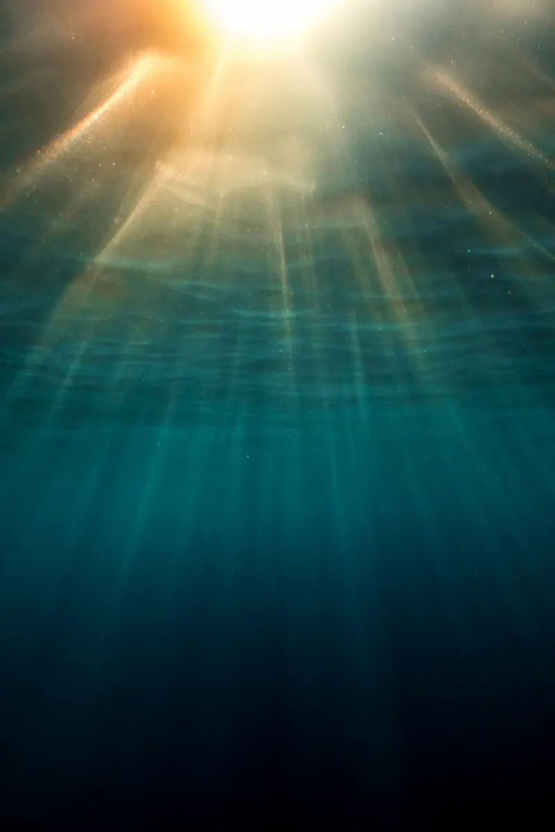 Sunlight filtering through deep blue water symbolizing emotional depth healing and hope emerging through trauma therapy annapolis
