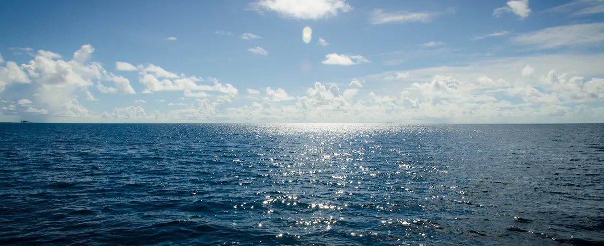 Sunlight reflecting across open ocean beneath blue sky conveying calm in anxiety therapy annapolis