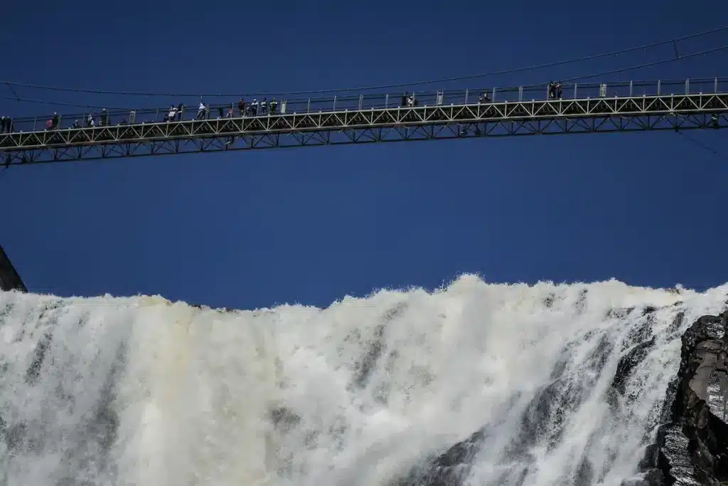 Suspension bridge above a powerful waterfall, reflecting resilience in depth-oriented therapy Annapolis