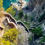 Winding cliffside staircase above the ocean, symbolizing life transitions, courage, and steady progress through challenges and healing